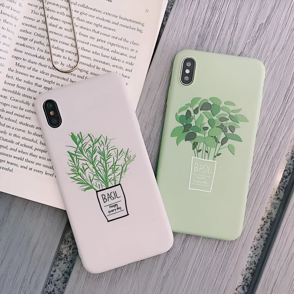 White silicone iPhone case with a painted green leaf plant design on the back.
