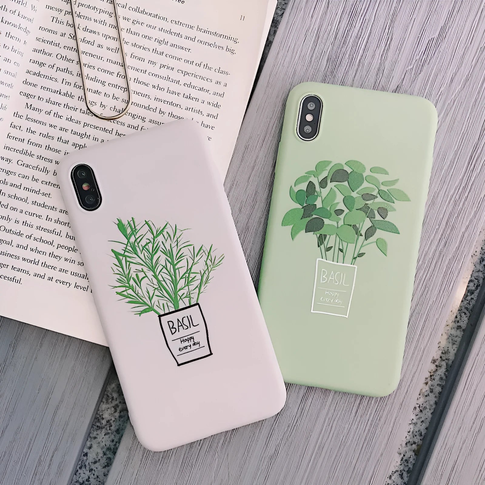 White silicone iPhone case with a painted green leaf plant design on the back.