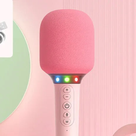 Pink Bluetooth children's handheld karaoke microphone with built-in speaker on white background