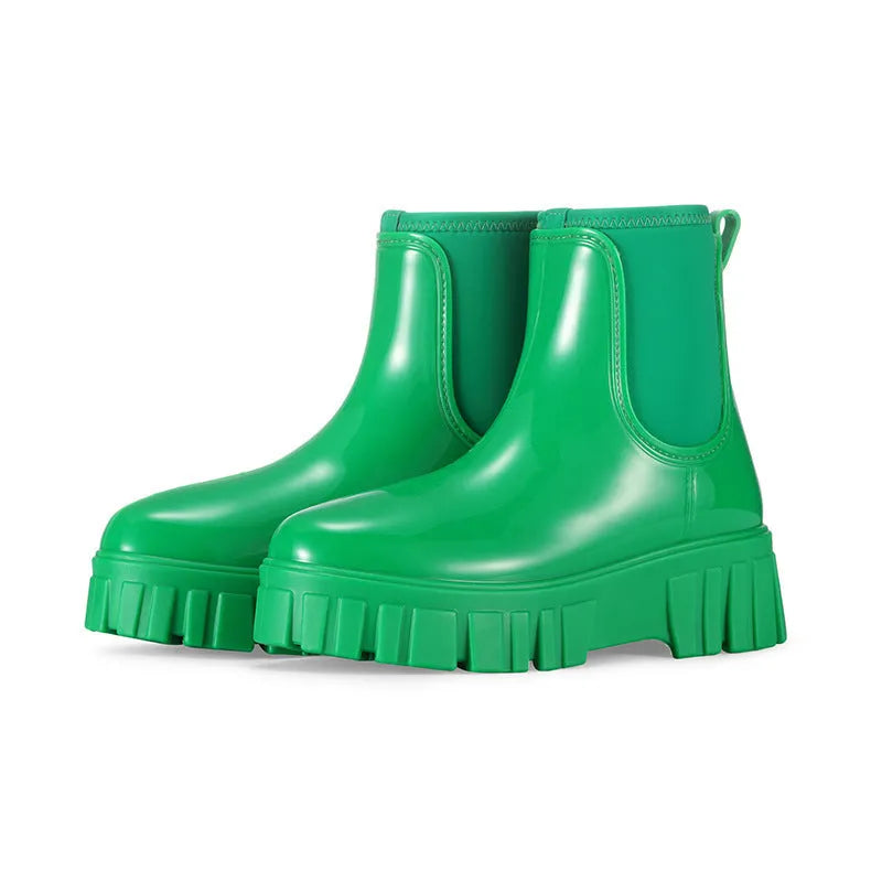 A pair of low tube PVC rain boots with a flat heel, shown in a solid colour on a white background.
