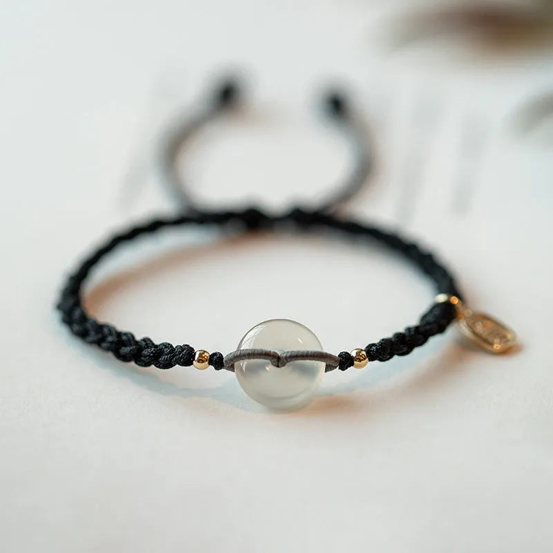 Crystal bracelet with woven rope strap and geometric square grain detailing in ethnic style