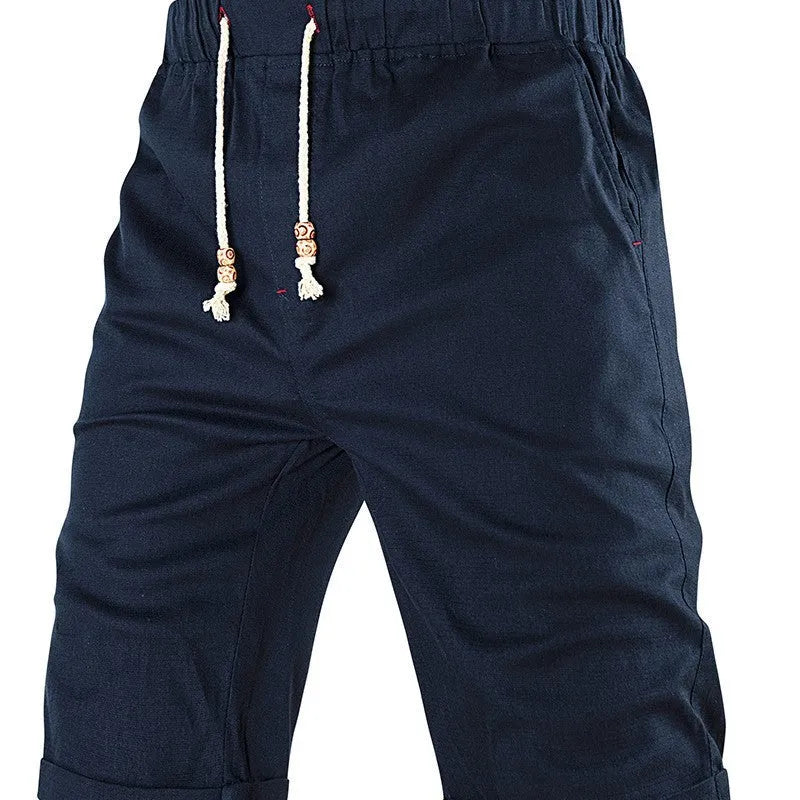 Men's solid colour cotton blend casual shorts with a drawstring waist and zip pocket.