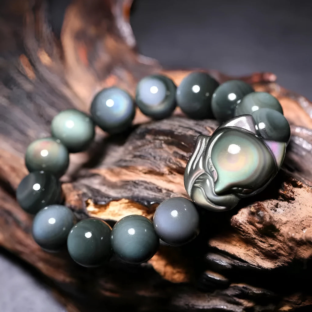 Obsidian stone bracelet with carved fox design in cartoon style, shown in various sizes
