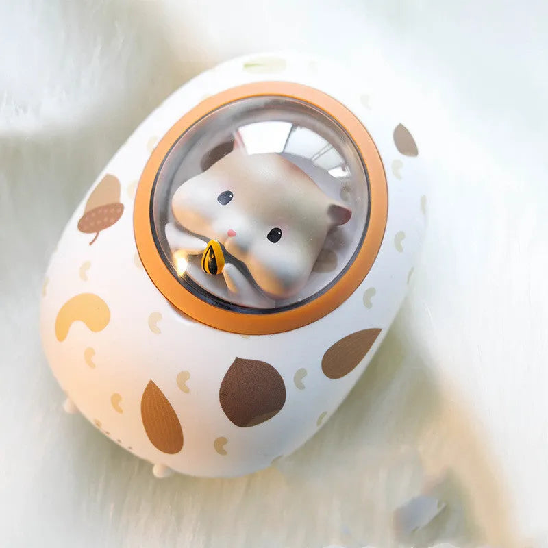White Hamster space capsule-shaped hand warmer and power bank with USB port