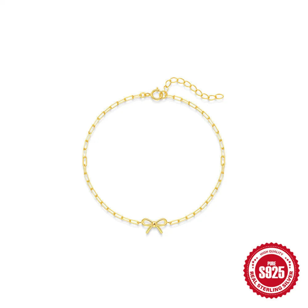 Gold plated S925 sterling silver bracelet with heart charm and geometric clip chain on wrist