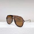 Black leopard print retro sunglasses with large elliptical frame on display.