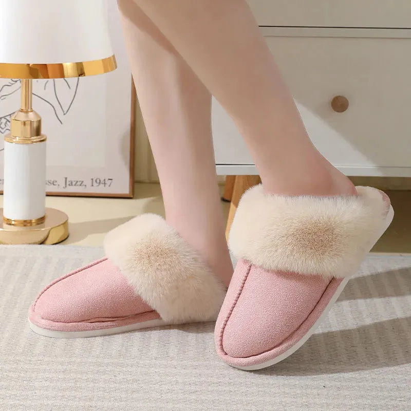 Brown plush indoor slippers with round toe, flat heel, and stitched detail on a PVC sole.