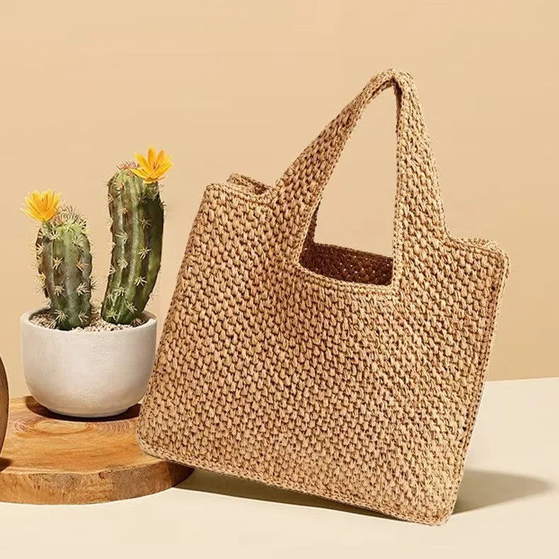 Straw woven bucket tote bag in beige colour showing woven texture and open top design