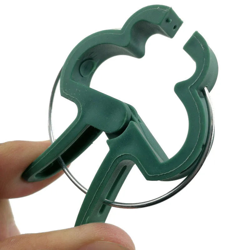 Green plastic and zinc plant fixing clips, showing large and small sizes for garden vine support.