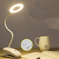 Modern clip-on rechargeable desk lamp with a white plastic shade and touch controls on its base.