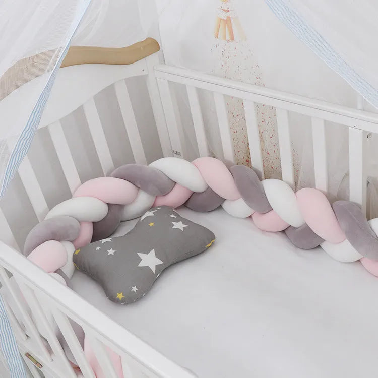 Baby cot bumper braid in spandex crystal velvet, shown in a light grey colour, wrapped around white crib rails.