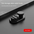 Dark green ABS silicone car cable hook with adhesive backing for organising data cables on a dashboard.