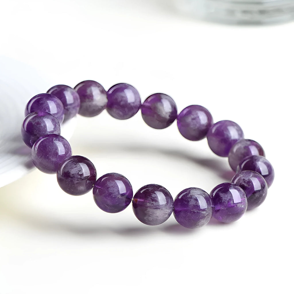 Snow Mountain feather amethyst crystal bracelet with scattered geometric beads and Ruyi element.