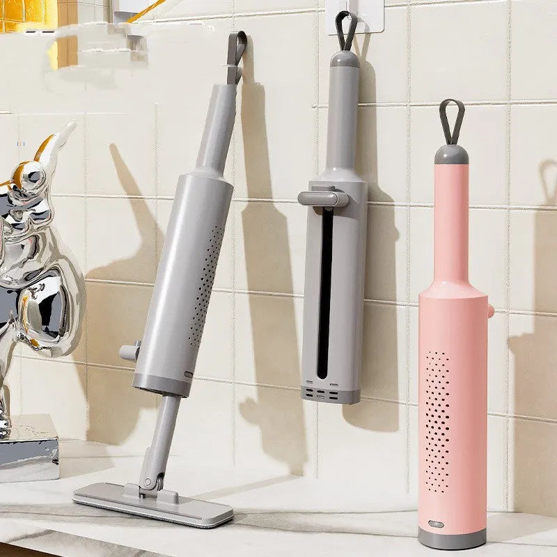 Rotatable self-squeeze mini flat mop with crevice brush and pink microfiber pad, shown extended to 19.3 inches.