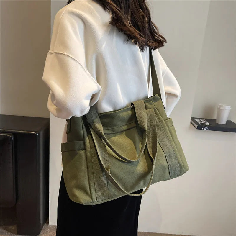 Large capacity polyester canvas shoulder tote bag in a solid colour, showing outer sandwich pocket.