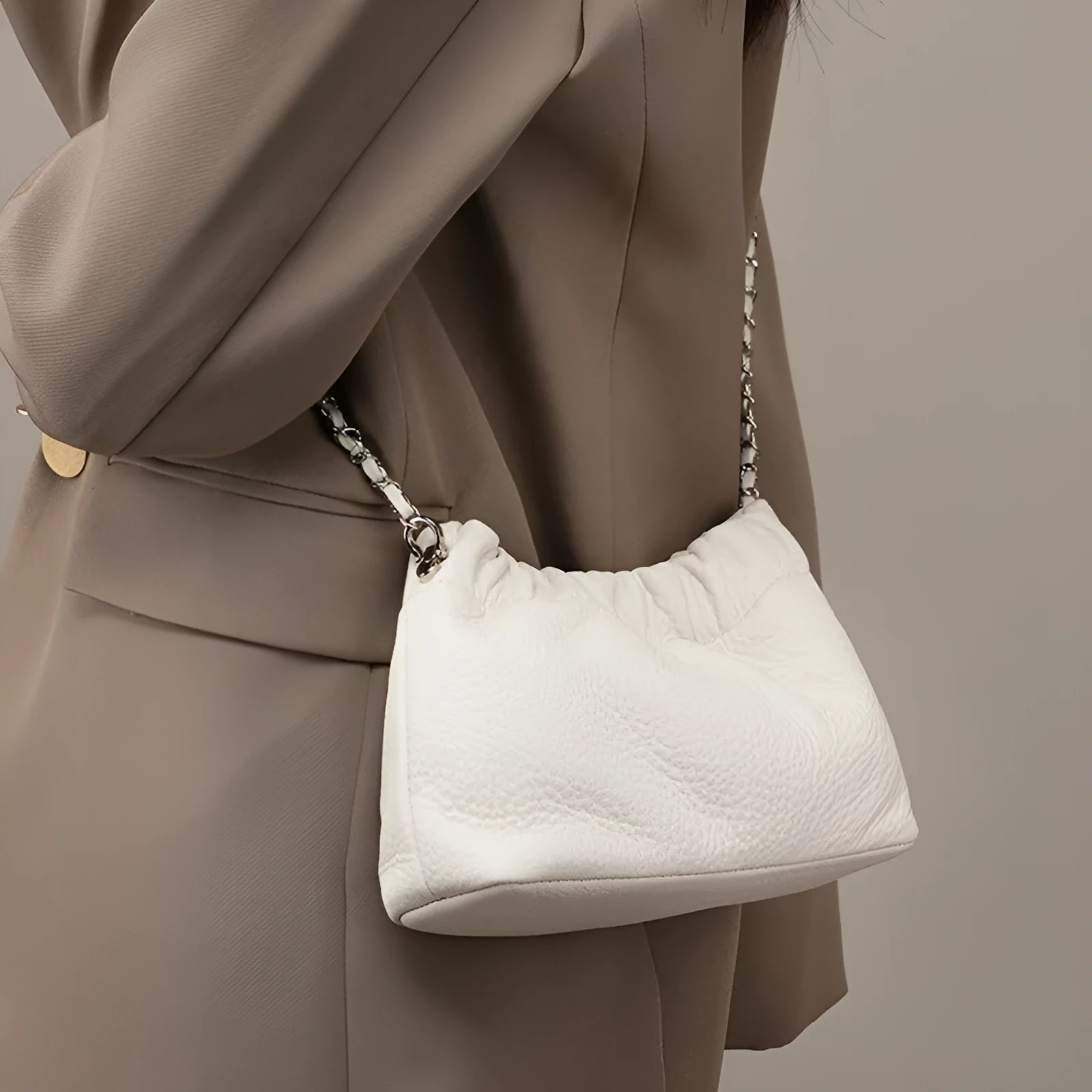 Women's soft cowhide leather crossbody bag in dumpling shape with a single strap.