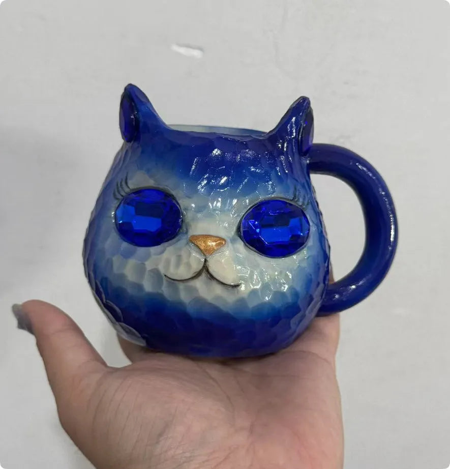 Resin cat cup crystal globe decorative ornament on a desk, shown in purple colour.
