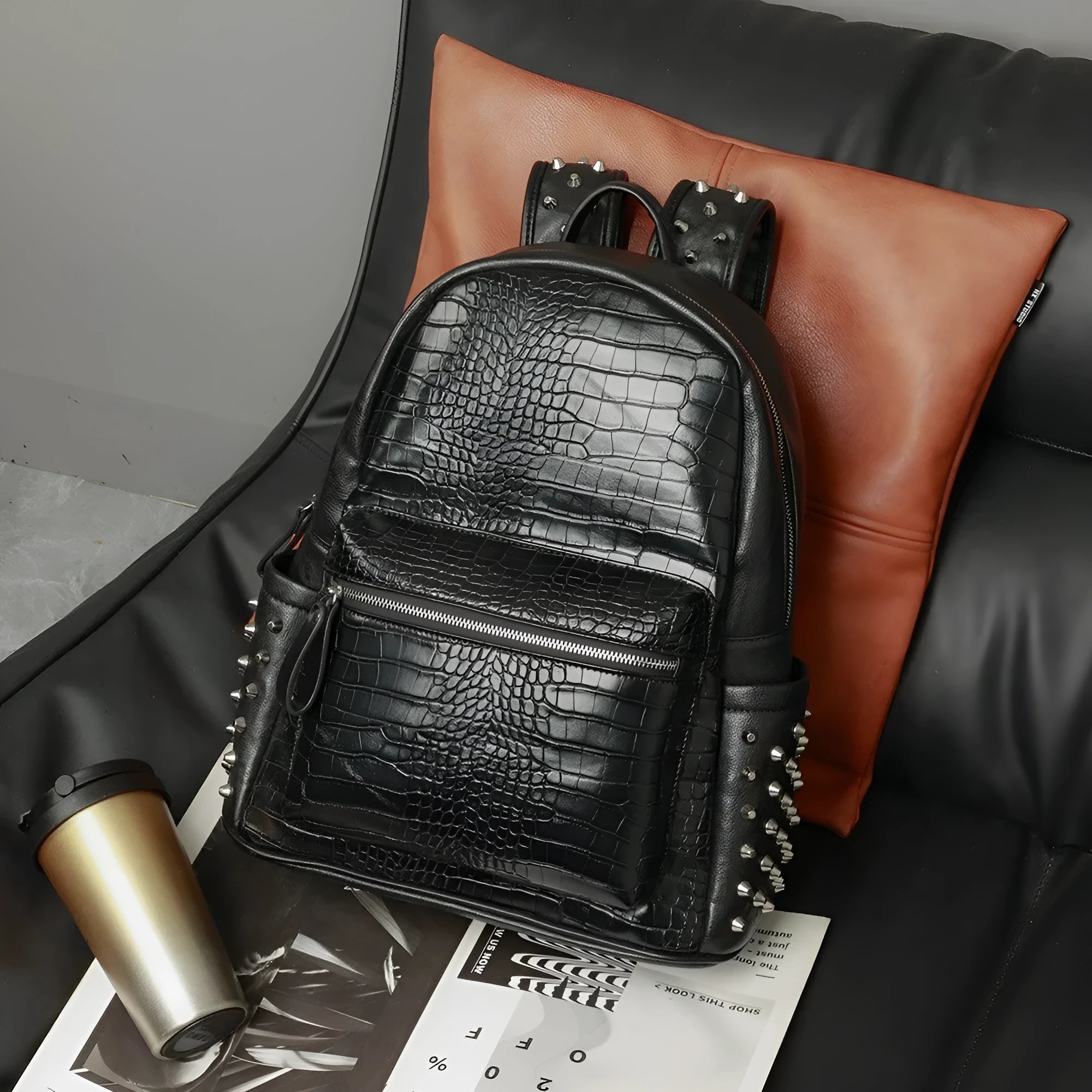 Black oil-wax PU leather computer schoolbag with rivets, showing large 36-55L capacity.