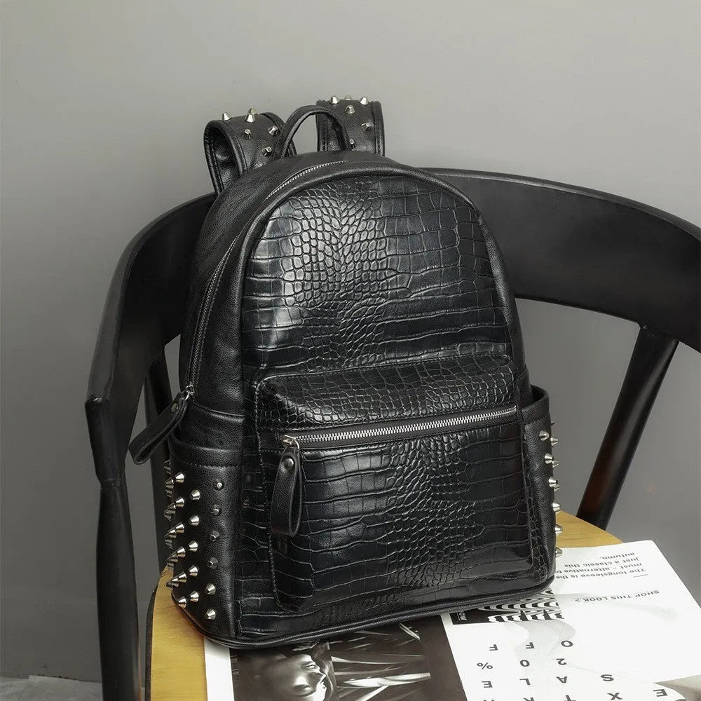 Black oil-wax PU leather computer schoolbag with rivets, showing large 36-55L capacity.