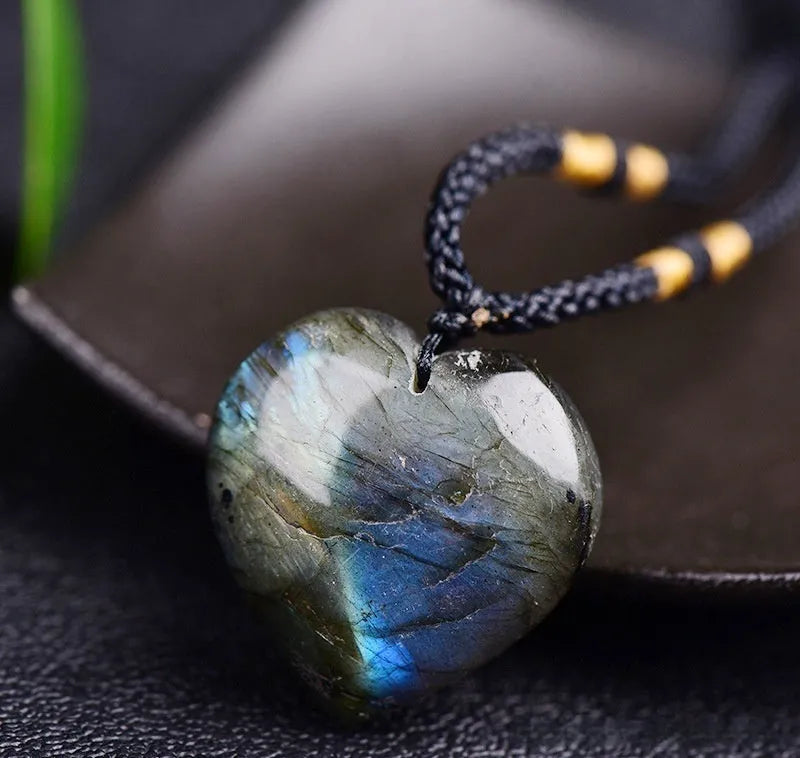 Light blue labradorite moonstone heart pendant necklace on a chain, geometric crystal design.