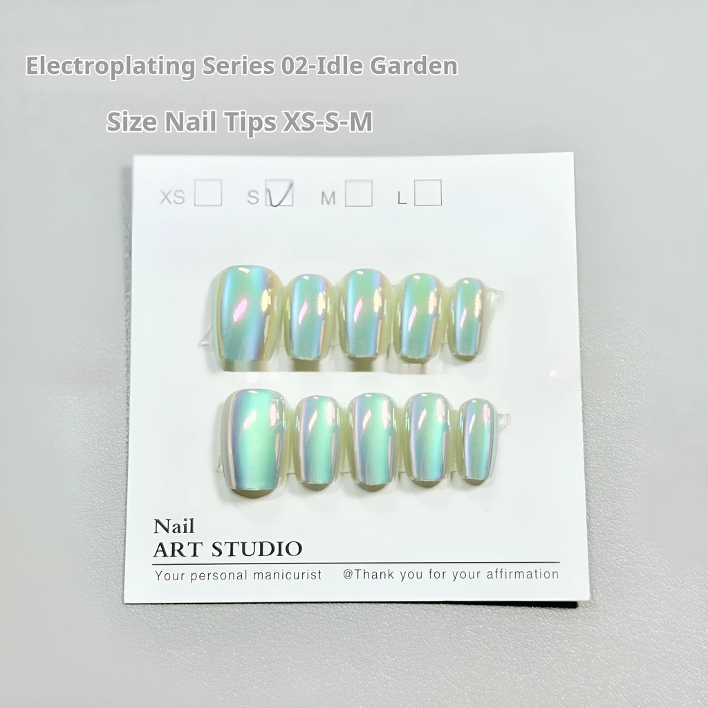Set of electroplated Cat's Eye false nails in short ladder lengths on a clear stand.