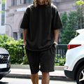 Men's casual sports suit set with grey round neck T-shirt and drawstring shorts on model