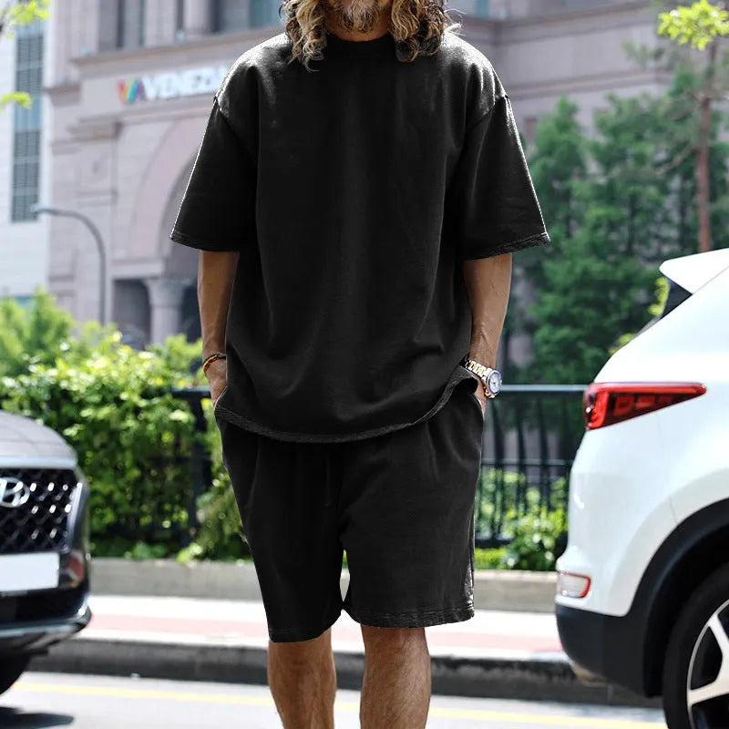 Men's casual sports suit set with grey round neck T-shirt and drawstring shorts on model