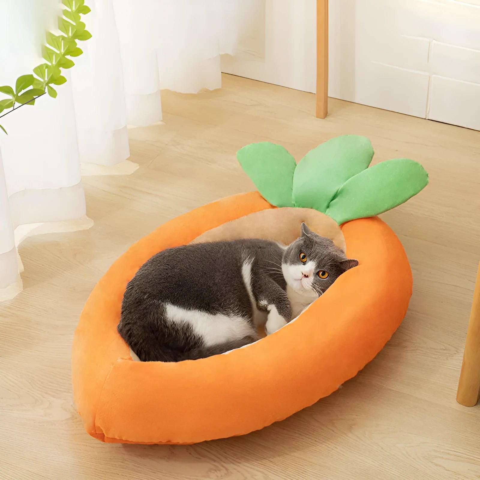 Carrot-shaped nesting dog bed with raised sides and a soft, washable blanket for small and medium pets