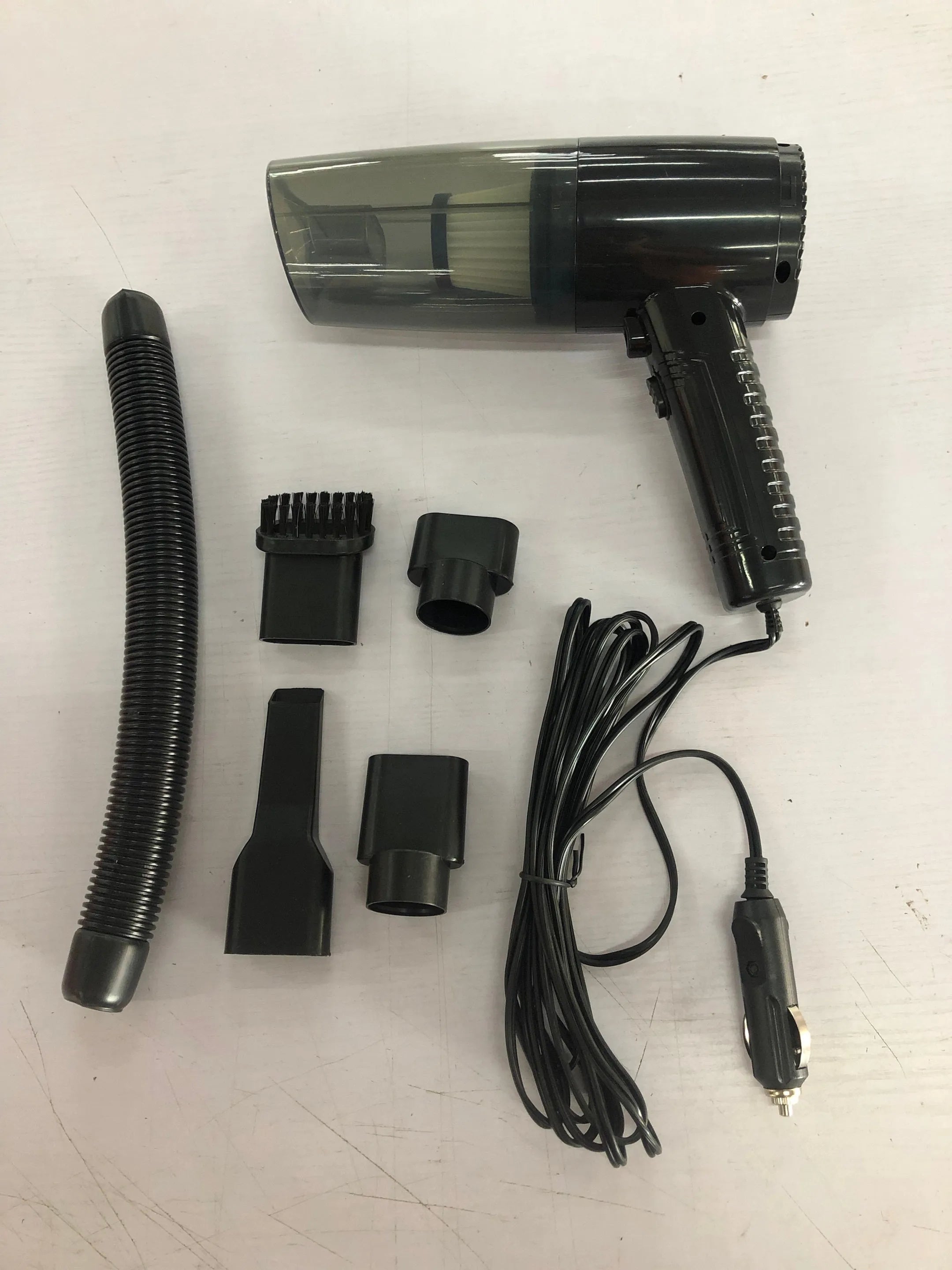 Starry Sky Black and Pearl White dual-purpose car vacuum cleaner with attachments and long power cable.