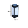 A set of waterproof solar-powered garden lights installed along a lawn edge and wall.