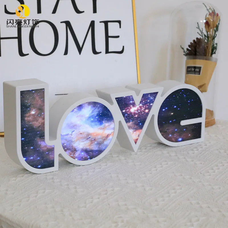 Rainbow style LED LOVE decorative table lamp with plastic shade on a table