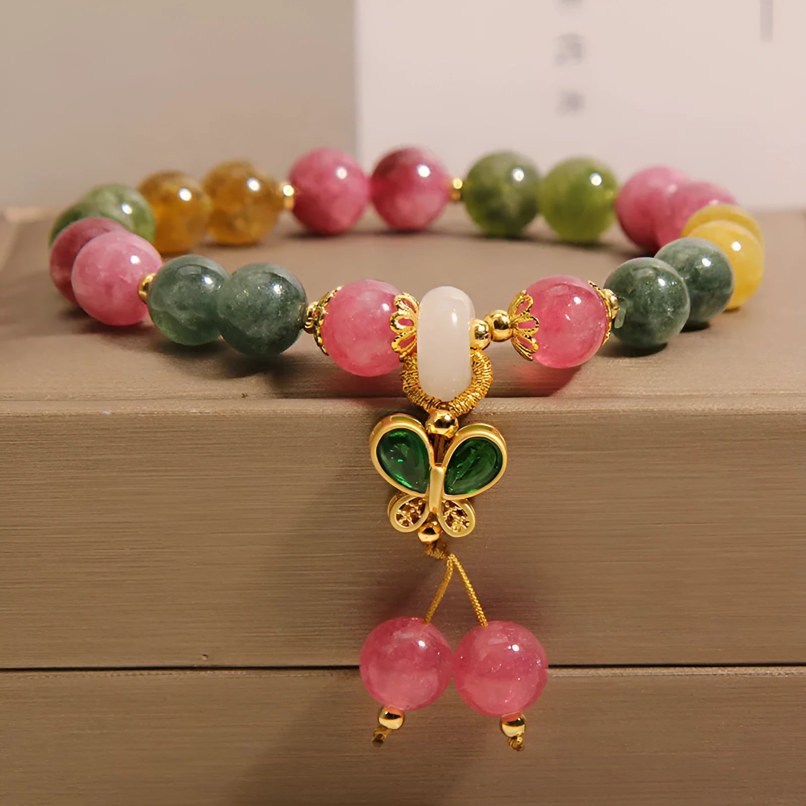 Women's tourmaline bracelet with a natural jade colour butterfly pendant and rhinestone details.