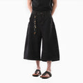 Man wearing black retro washed straight-leg denim cropped pants with side pockets.