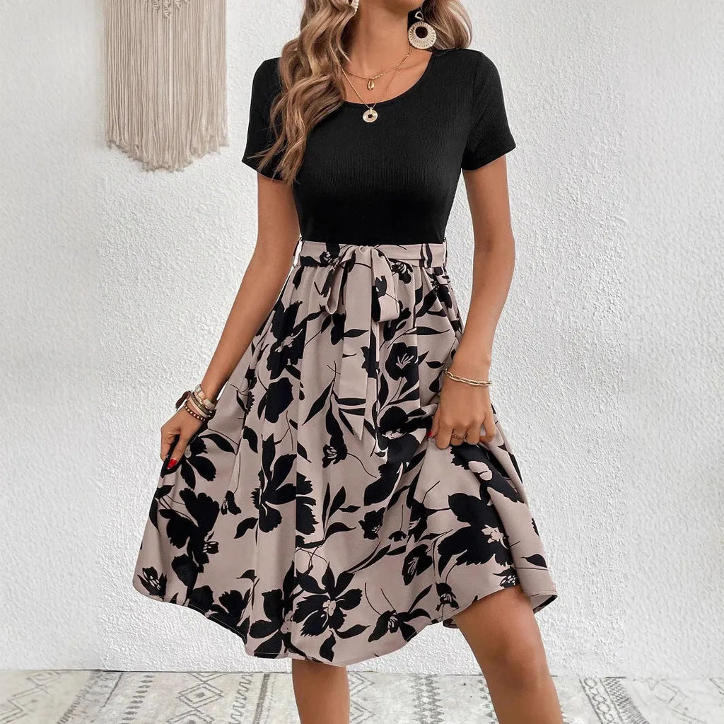 Women's khaki floral print A-line dress with lace-up front and shoulder strap details.