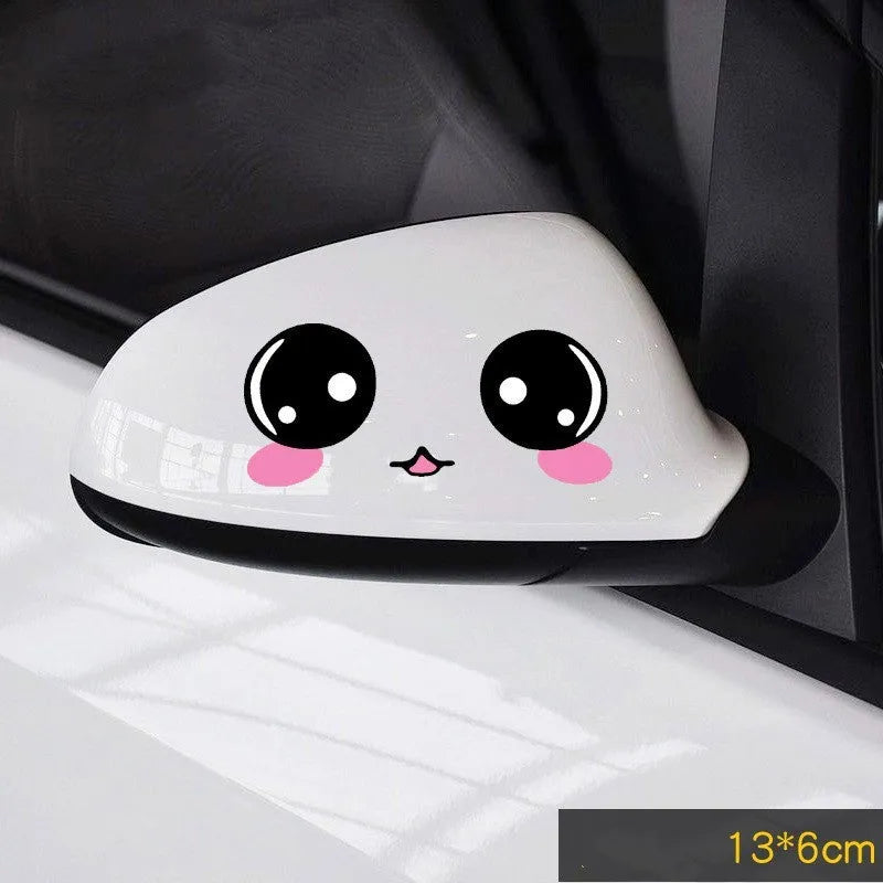Pair of reflective cartoon eye car stickers on a vehicle rearview mirror.