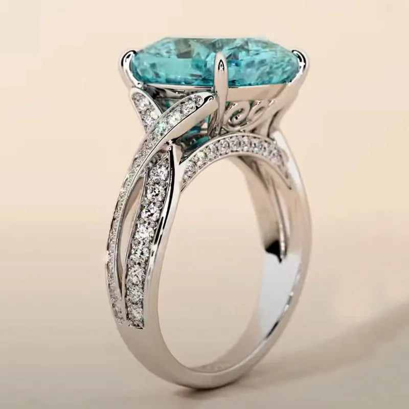 Square blue cubic zirconia women's fashion ring with adjustable metal band on white background