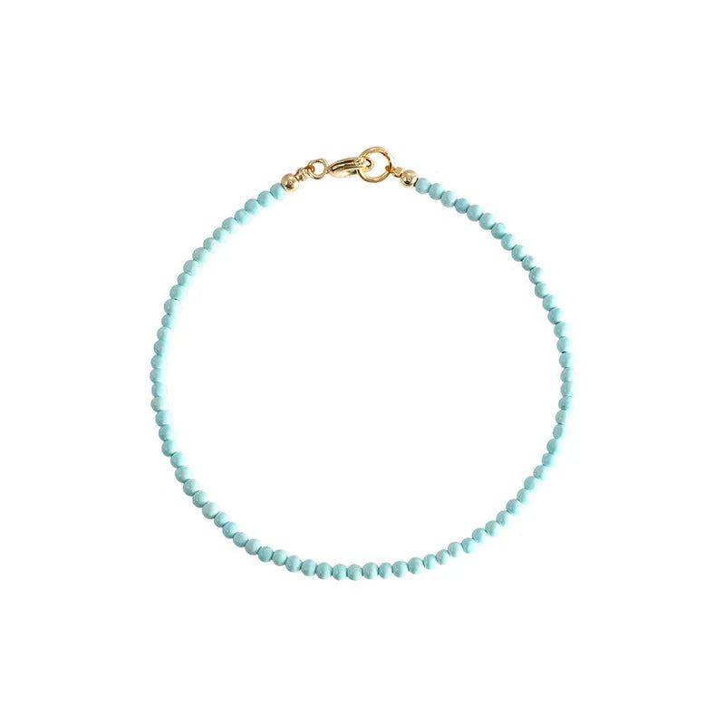 Close-up of a geometric bracelet made from small 2mm turquoise beads, shown in both raw and polished finishes, with a sizing chart for 14cm, 15cm, and 16cm wrists.