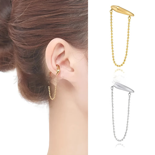 Ball chain tassel ear clip in gold on left ear, copper geometric U-shaped design