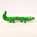 Green lizard-shaped dog chew toy with textured surface and squeaker for teeth cleaning
