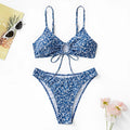 Blue three-piece swimsuit set with top and shorts on white background