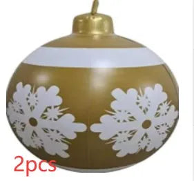 Large red and white striped inflatable Christmas ball ornament hanging on an outdoor tree