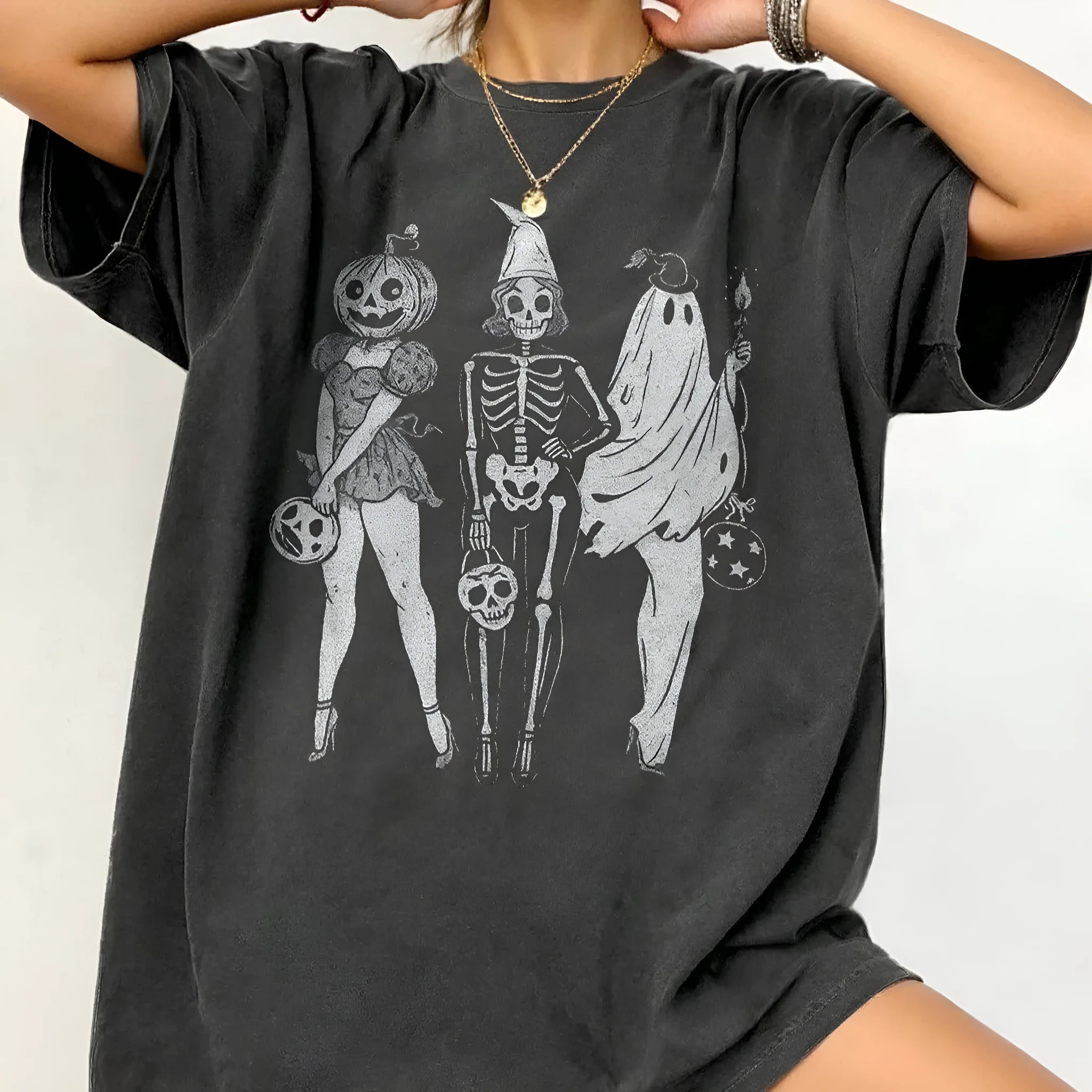Loose short-sleeve cotton T-shirt on a hanger, showing round neckline, available in black, green, grey, and orange.