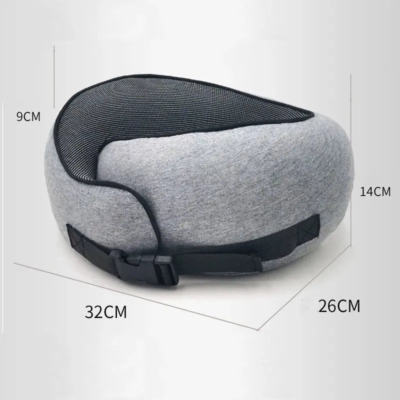 U-shaped memory foam travel neck pillow rolled up next to its carry bag, showing navy blue and grey colour options.