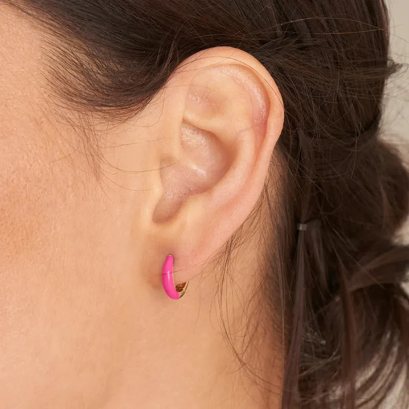 Oval-shaped curved drop earrings with colourful epoxy resin drip finish and silver metal pin.