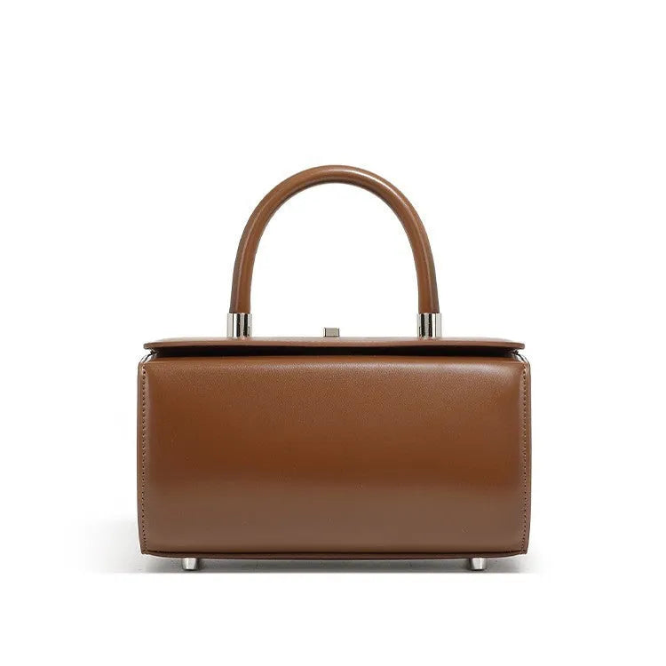 Women's leather crossbody bag in clamshell design showing internal phone and file pockets.