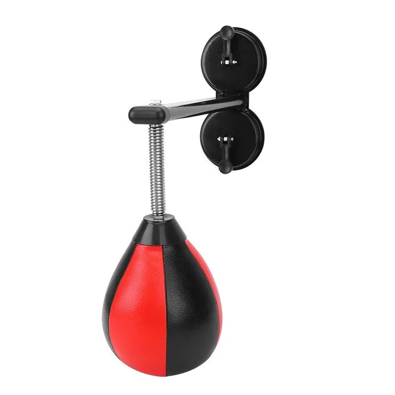 Pear-shaped hanging boxing training ball with red and black head on elastic cord and dual suction cup base.