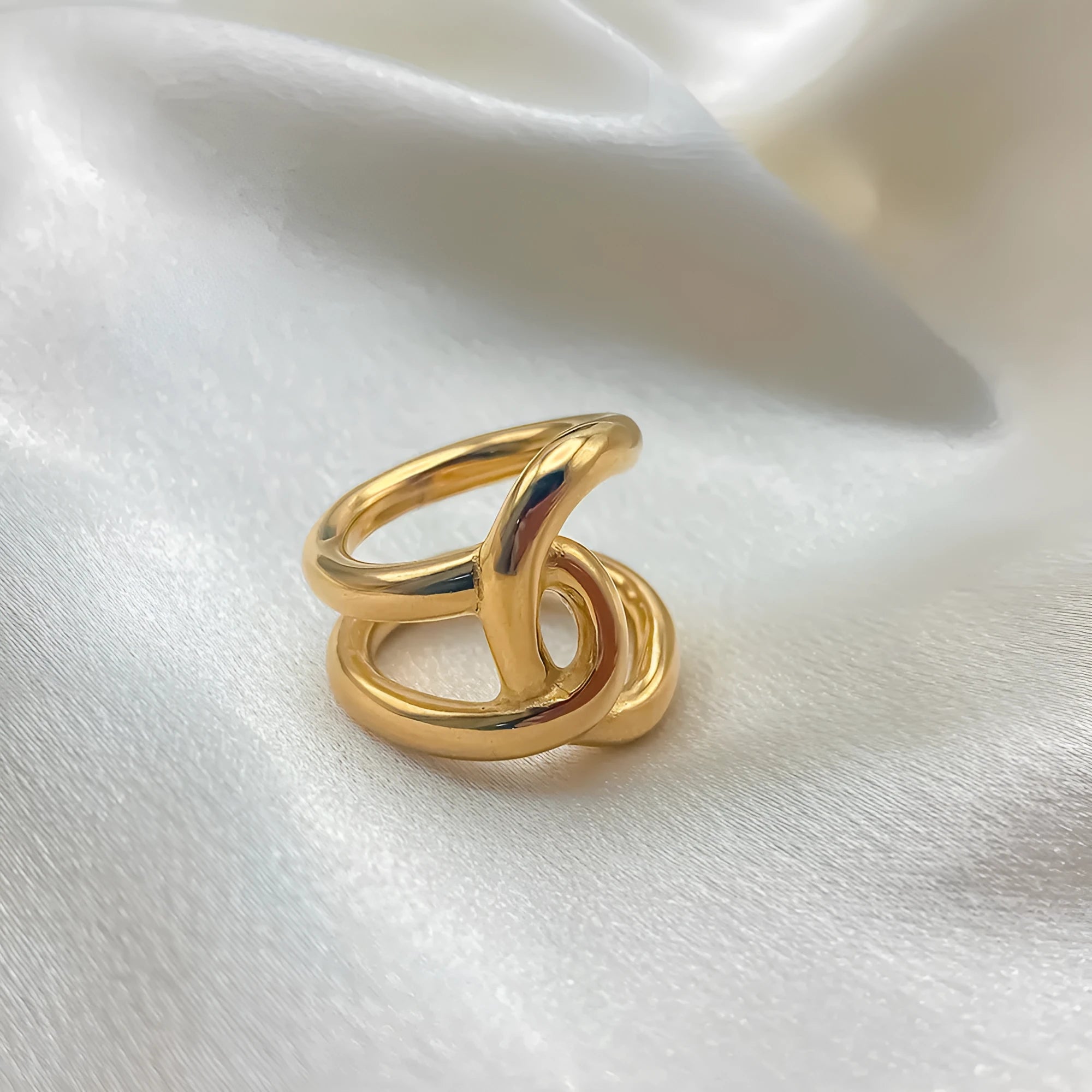 Women's adjustable knotted geometric ring in stainless steel showing U-shape opening design