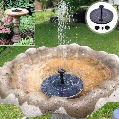 Black solar garden fountain pump with panel and four spray nozzles on grass