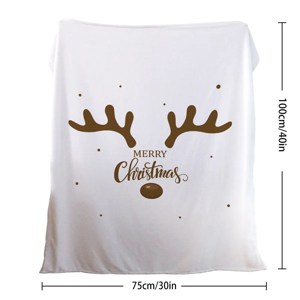 White flannel velvet deer antler pattern Christmas blanket on a sofa