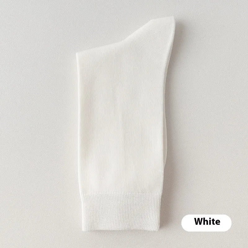 Five pairs of men's solid colour mid-calf socks made from combed cotton, shown in assorted shades.